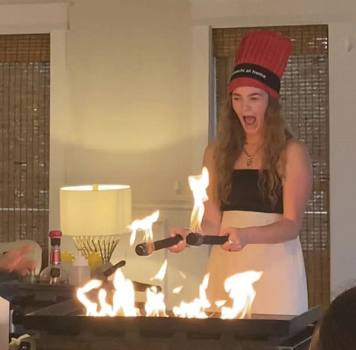 Guest enjoying an interactive hibachi fire experience at a private party